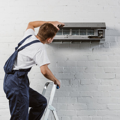 technician providing air conditioner repair