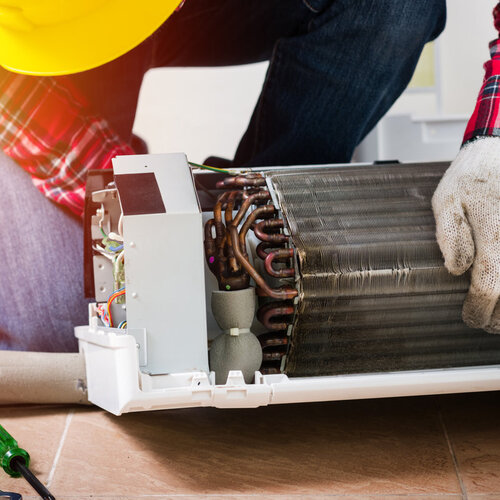 technician providing air conditioner parts replacement