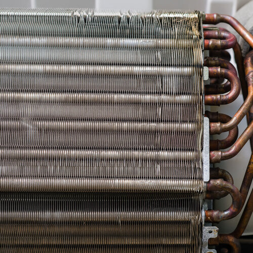 close-up of dirty and rusted air conditioner coils