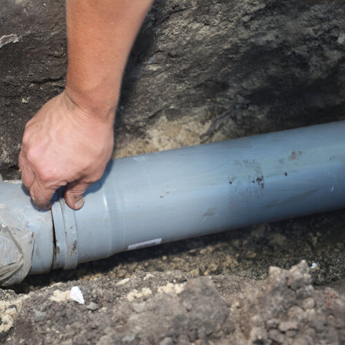 close-up of a plumber providing sewer line repairs