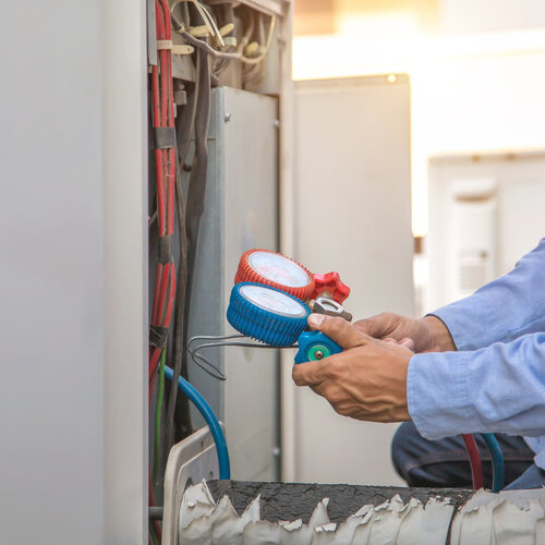 technician working on an air conditioning system