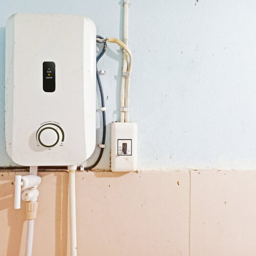 tankless water heater against a wall