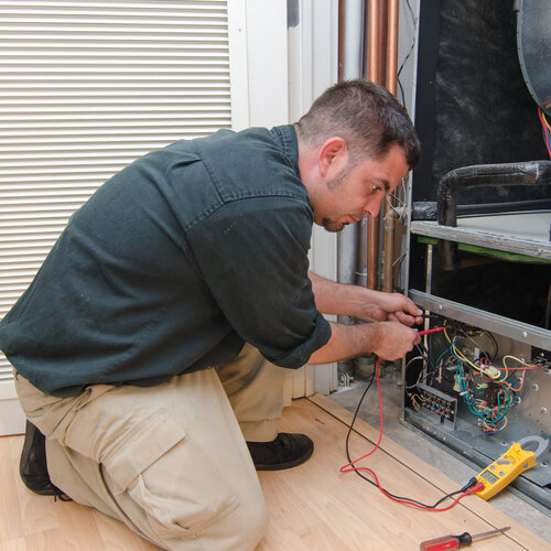 technician working on an air conditioning system