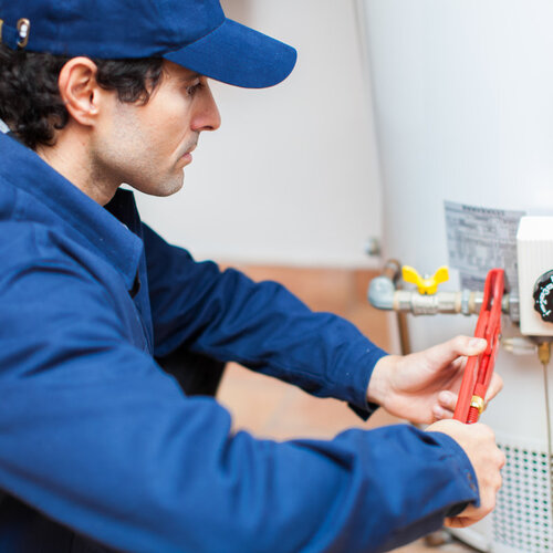 plumber working on a hot water heater