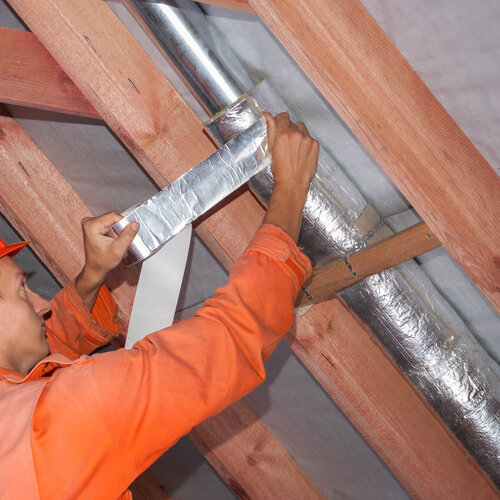professional working on a home's air ducts